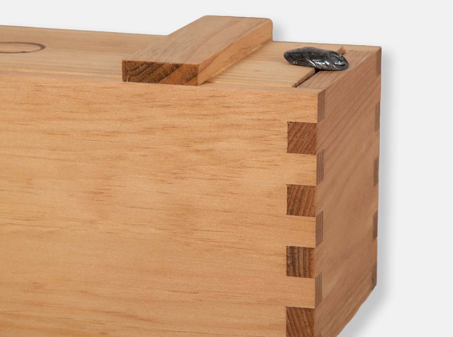 Close-up of a box-joint corner with a barrel-twist detail.